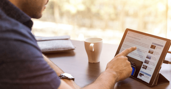 A man pointing at something on his Ipad