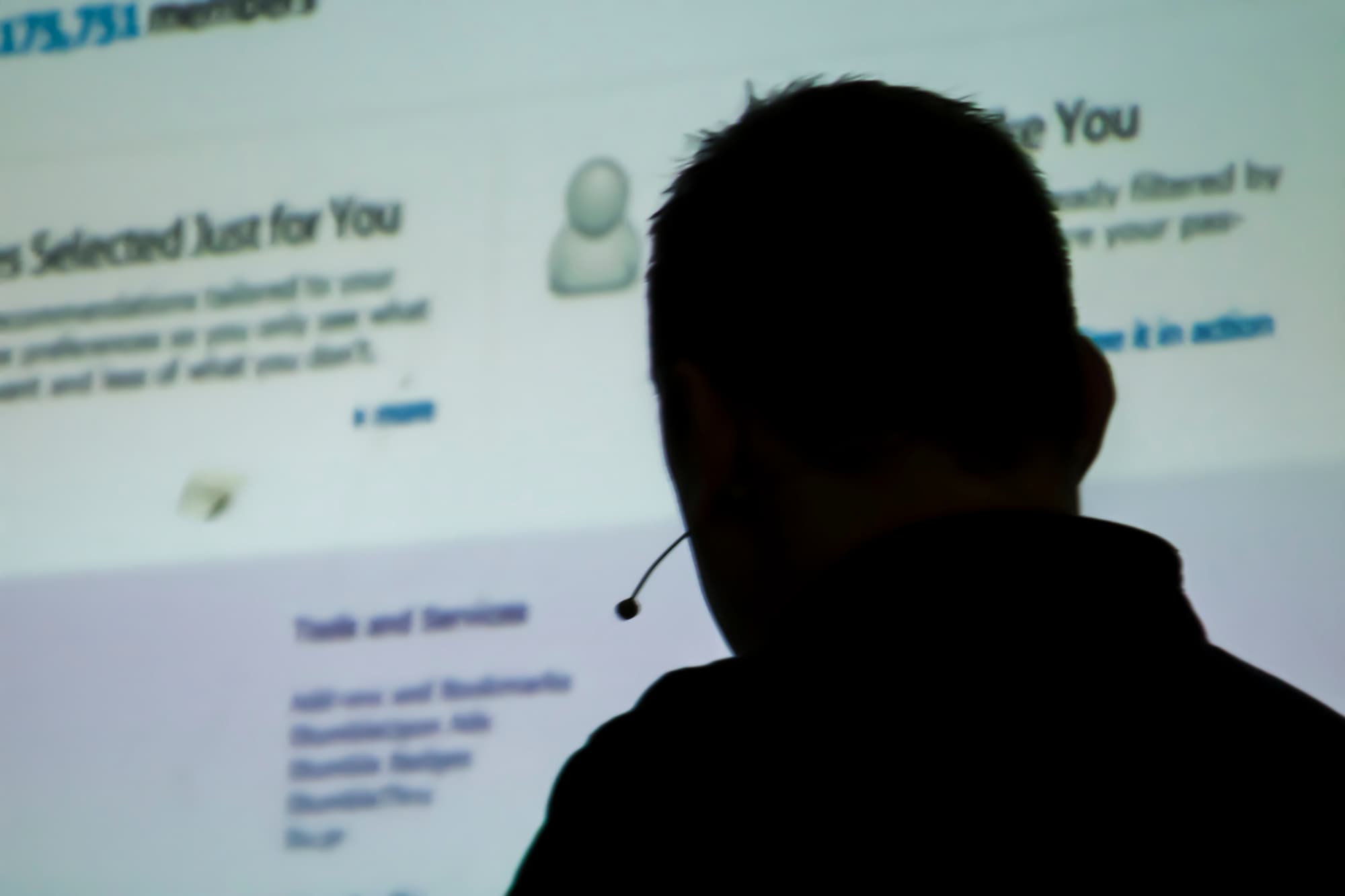 Silueta de un hombre frente a una pantalla con el logo de Facebook, simbolizando el phishing en redes sociales.