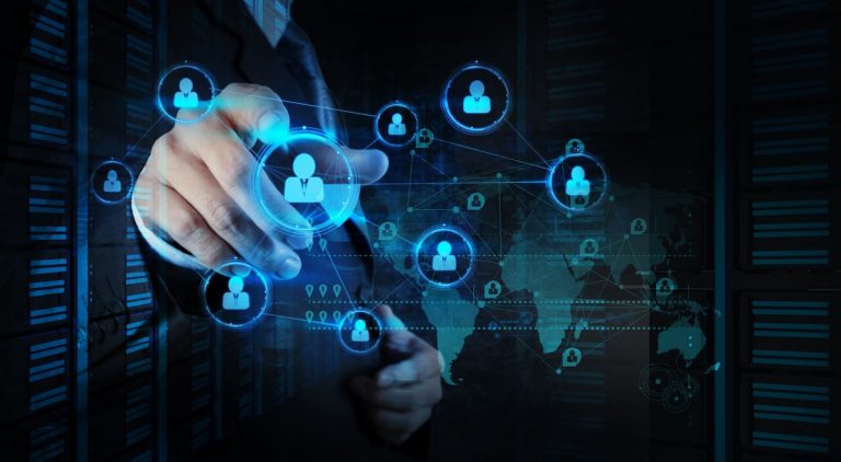 Mano de un empresario tocando una red de íconos sociales sobre un fondo oscuro, simbolizando la protección contra DDoS.