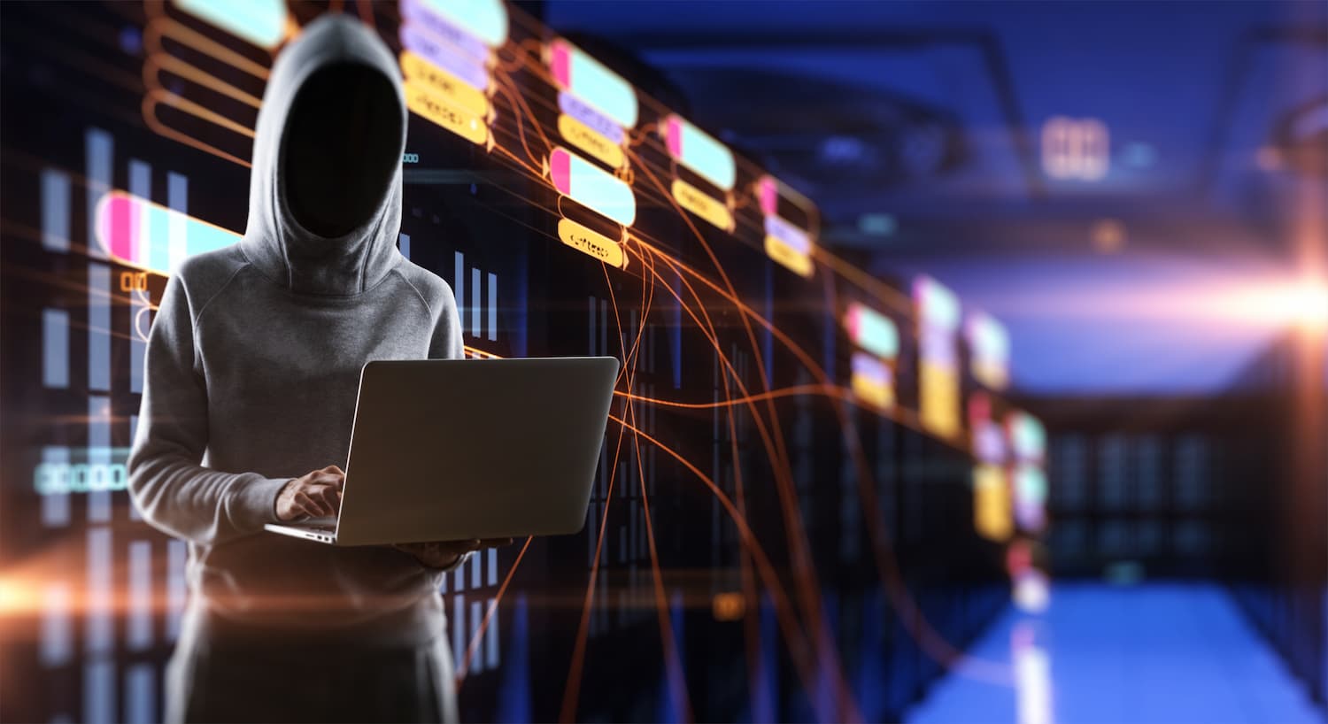 Persona con capucha frente a un ordenador, simbolizando el concepto de phishing y ciberseguridad.